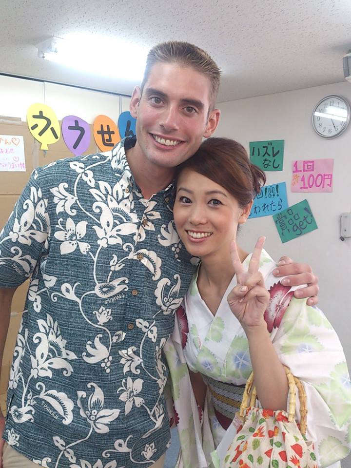 Students in front of a traditional Okinawan building