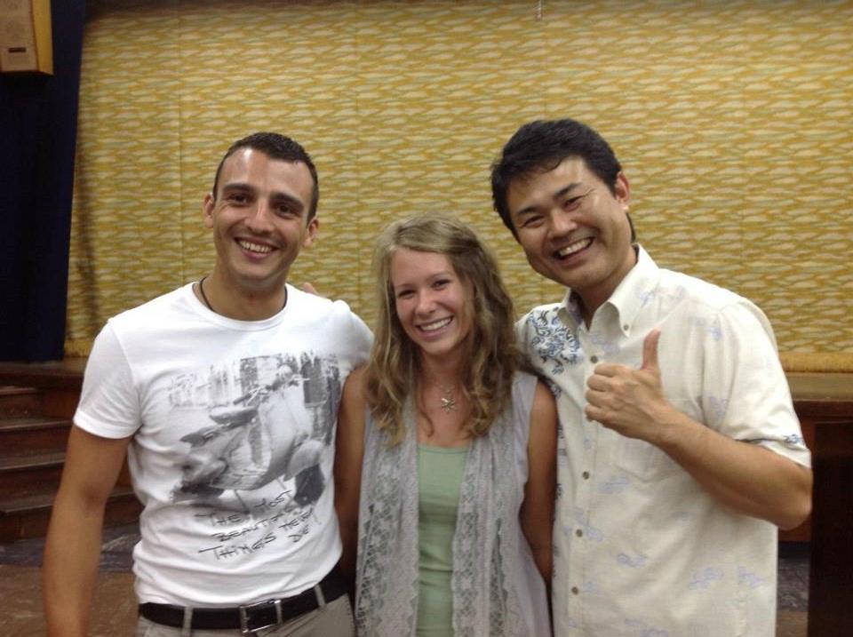 Students in front of a traditional Okinawan building